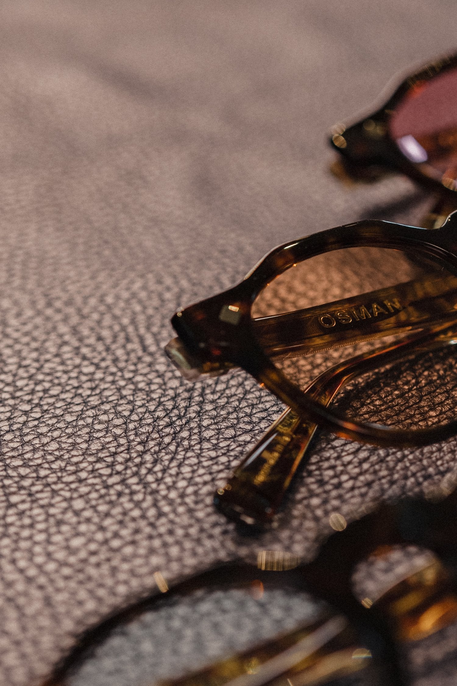 Osman Abdul Razak menswear MMXXIV sunglasses offering timeless luxury with smoked blue lens detail