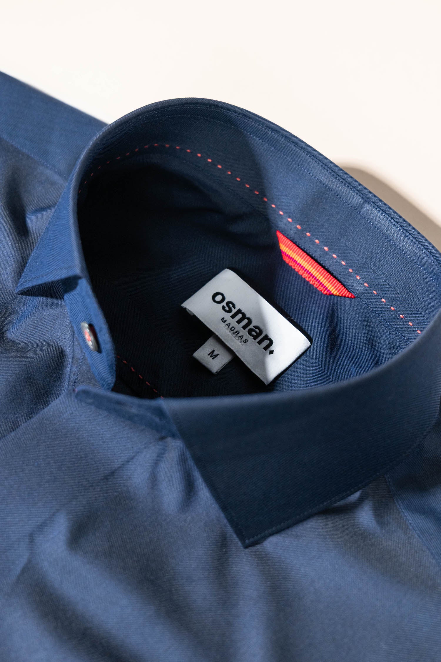 Bespoke-inspired menswear from Osman Abdul Razak – structured navy shirt with rolled sleeves