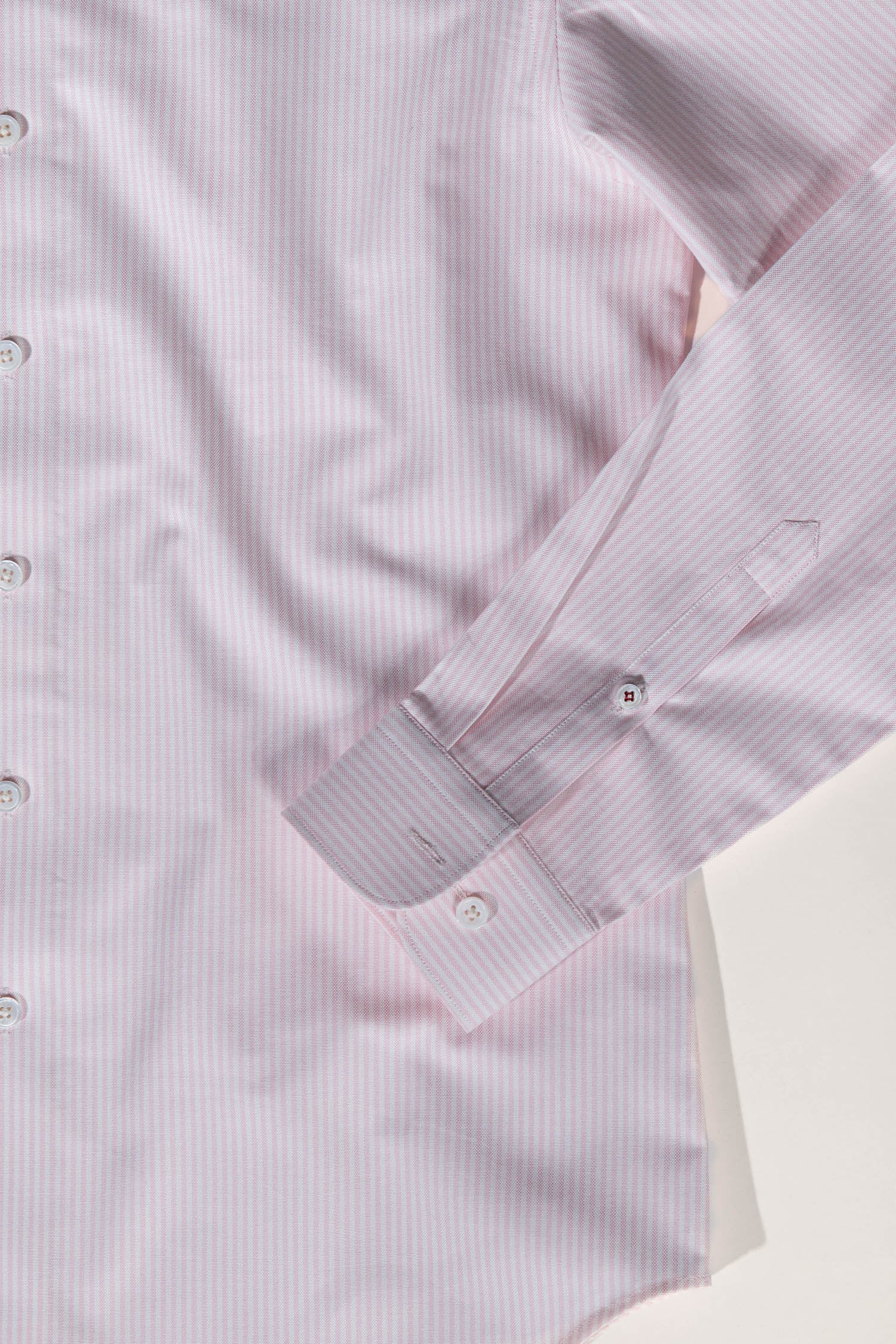 Refined menswear by Osman Abdul Razak pink striped shirt designed to elongate the form