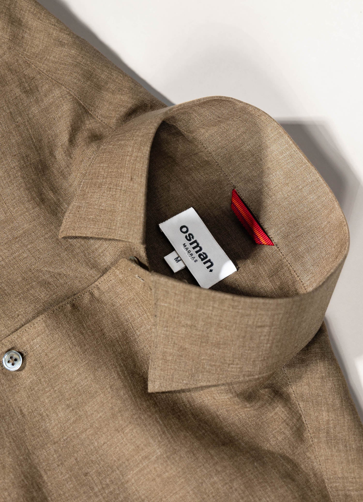 Tailored menswear by Osman Abdul Razak – relaxed olive linen shirt for coastal-inspired dressing