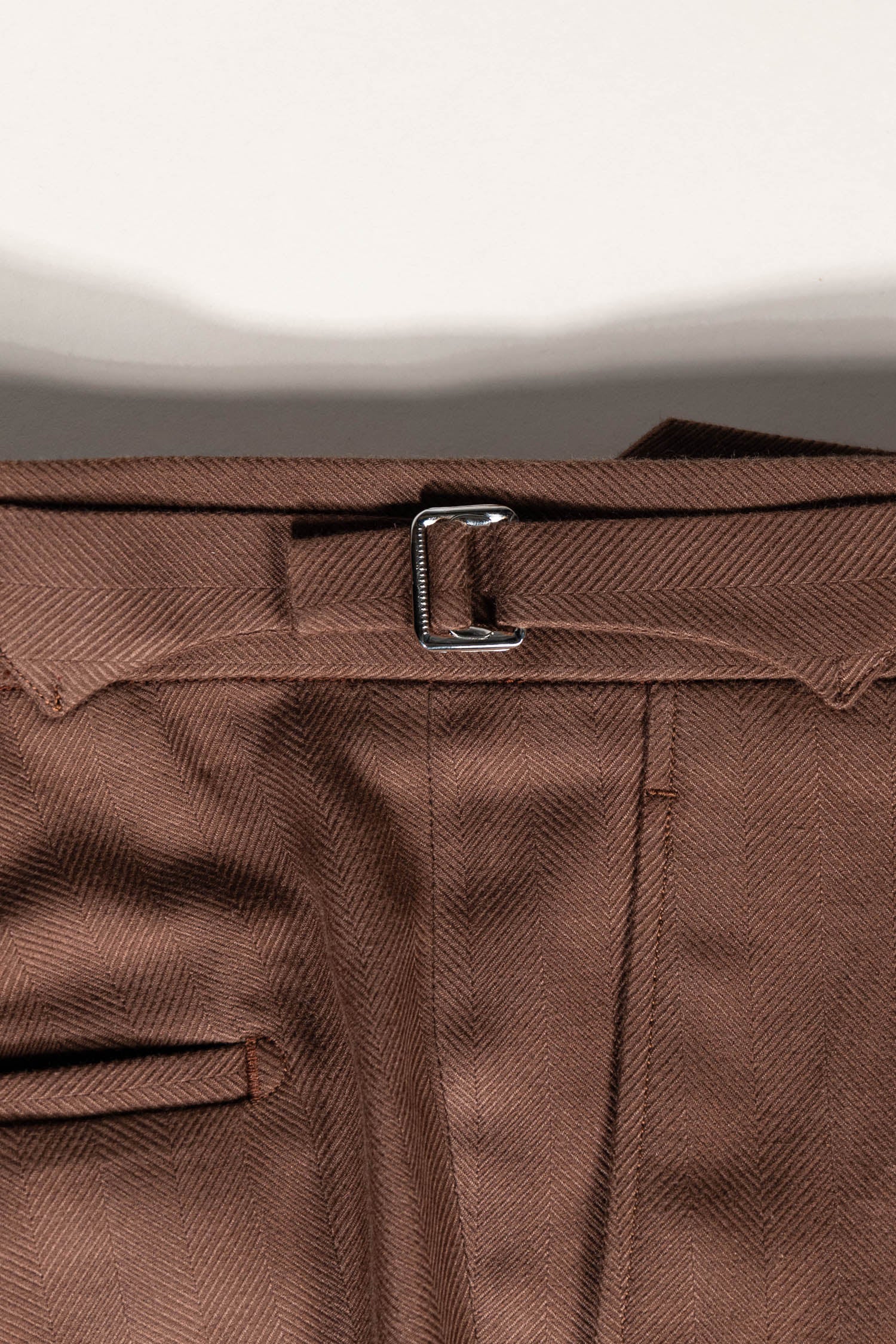 Osman Abdul Razak luxury menswear – tonal cinnamon trouser pairing seamlessly with creams, olives, and blues
