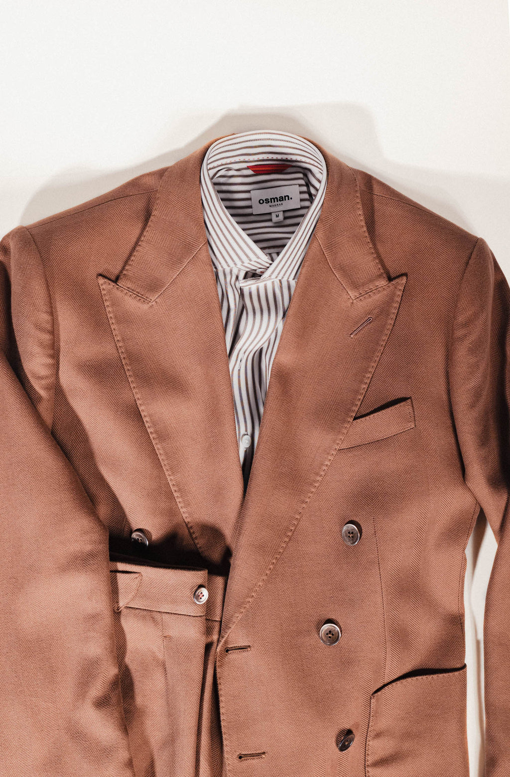Osman Abdul Razak menswear – half-lined brown jacket with flap pockets and peak lapels