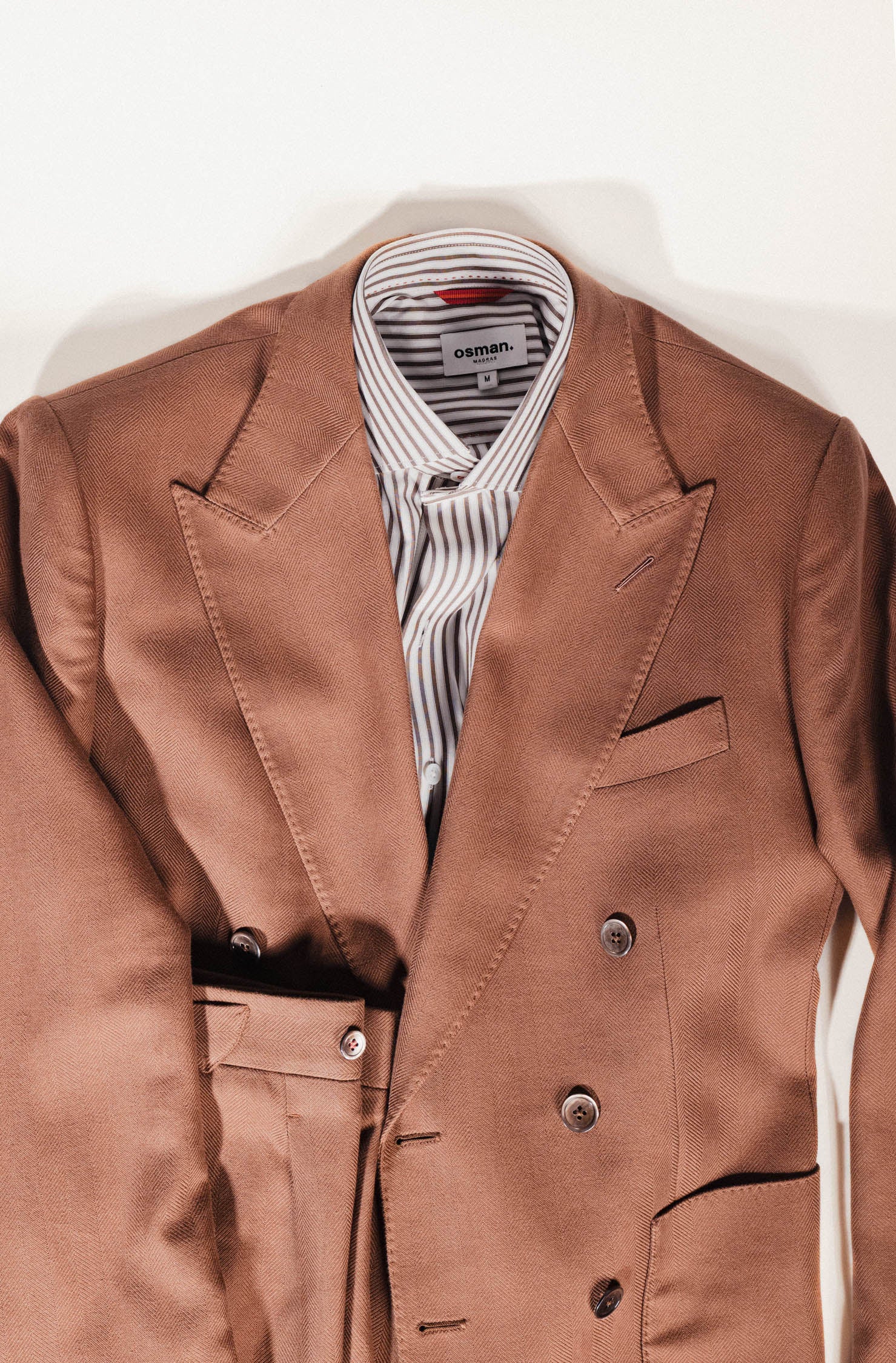 Osman Abdul Razak menswear – half-lined brown jacket with flap pockets and peak lapels