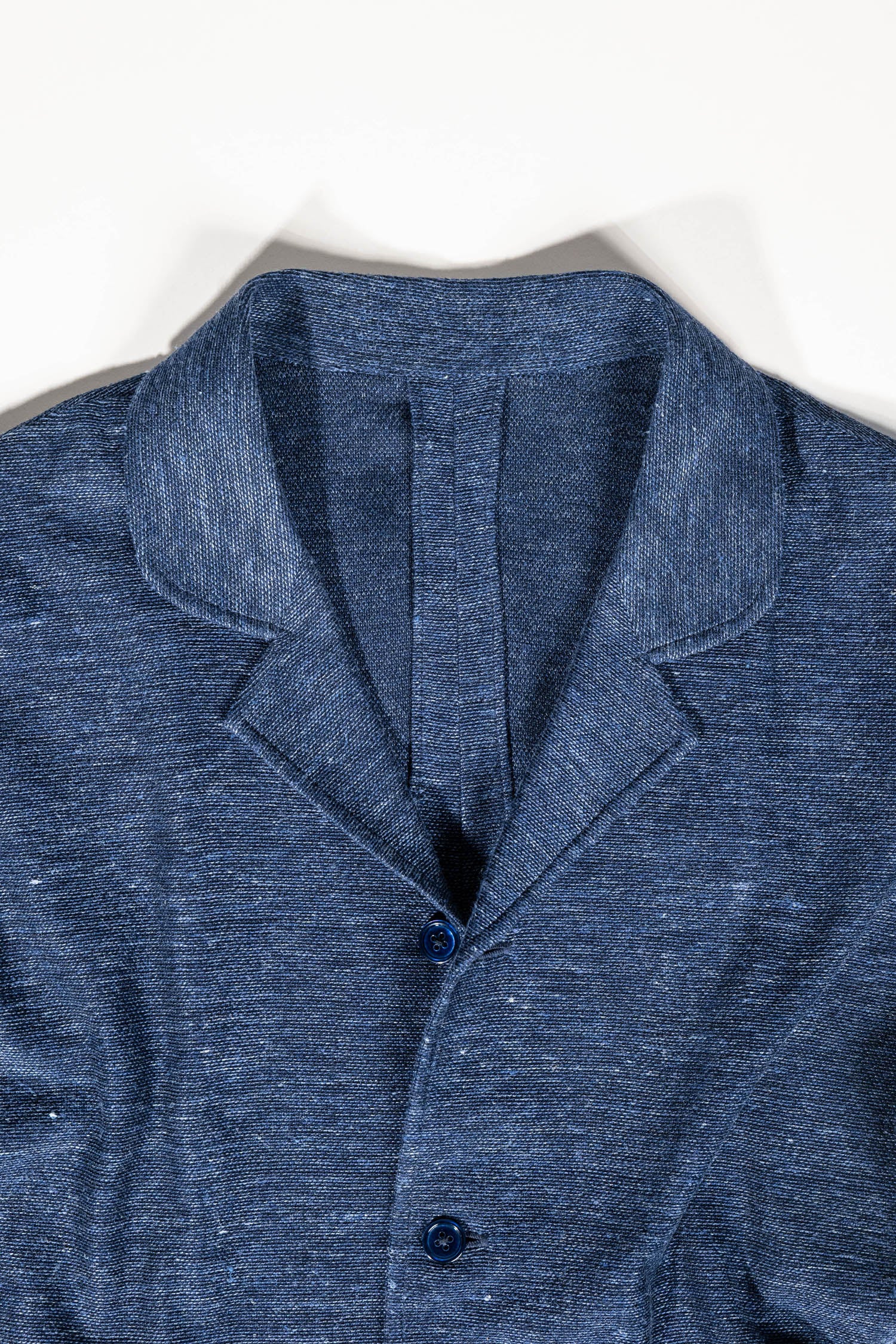 Refined menswear by Osman Abdul Razak – deep navy layering gilet with four-button closure