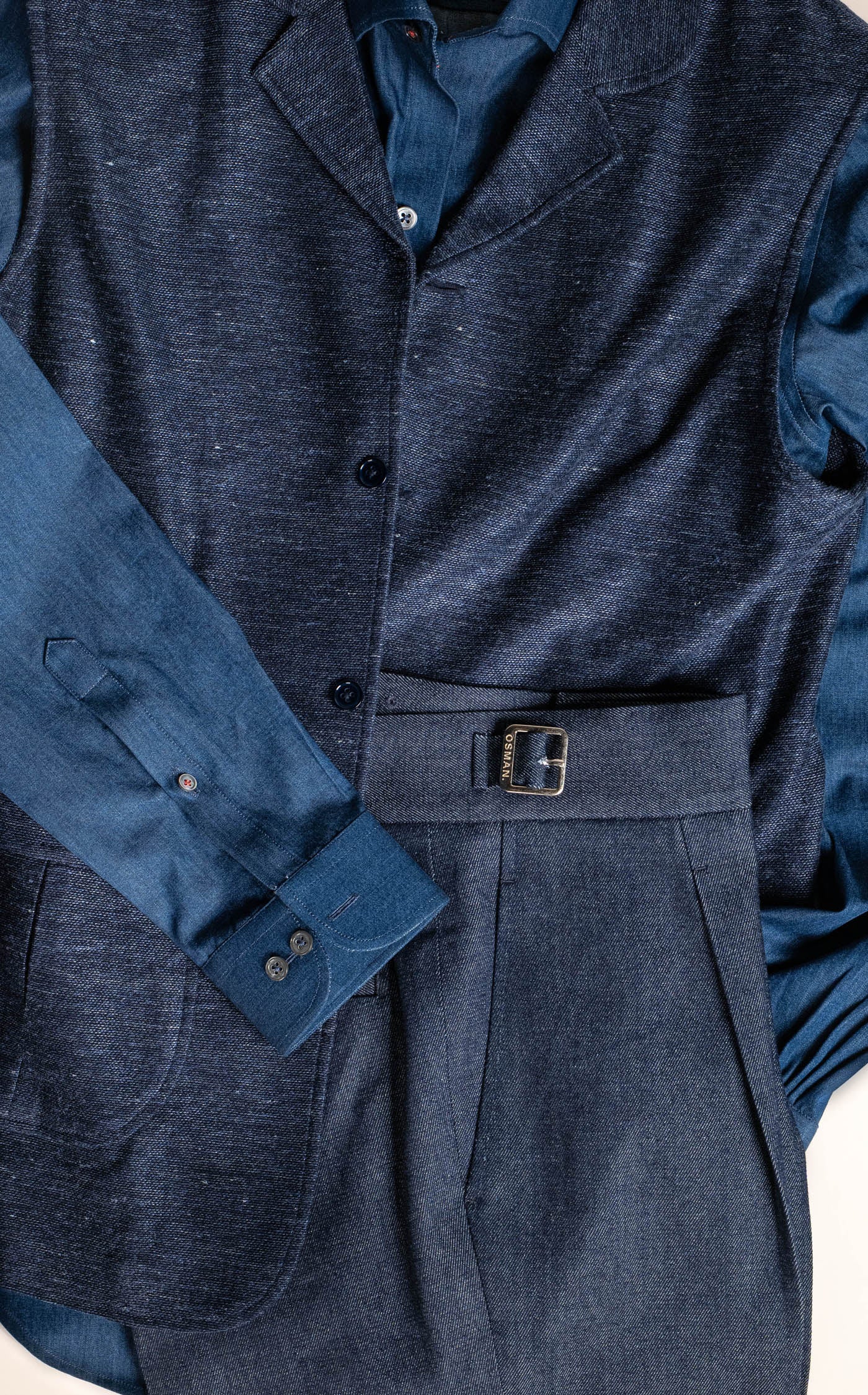 Structured menswear by Osman Abdul Razak – navy gilet adding warmth without bulk