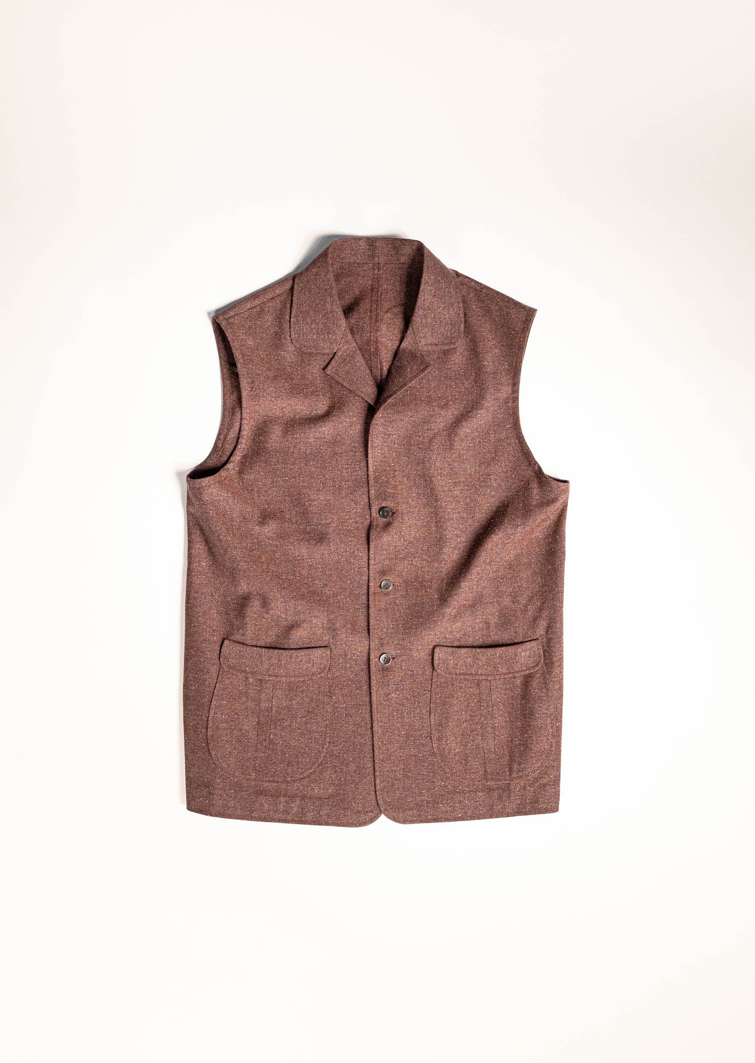 Osman Abdul Razak menswear – Rust Gilet with scissor-pleat pockets, stand collar, and contrast stitching