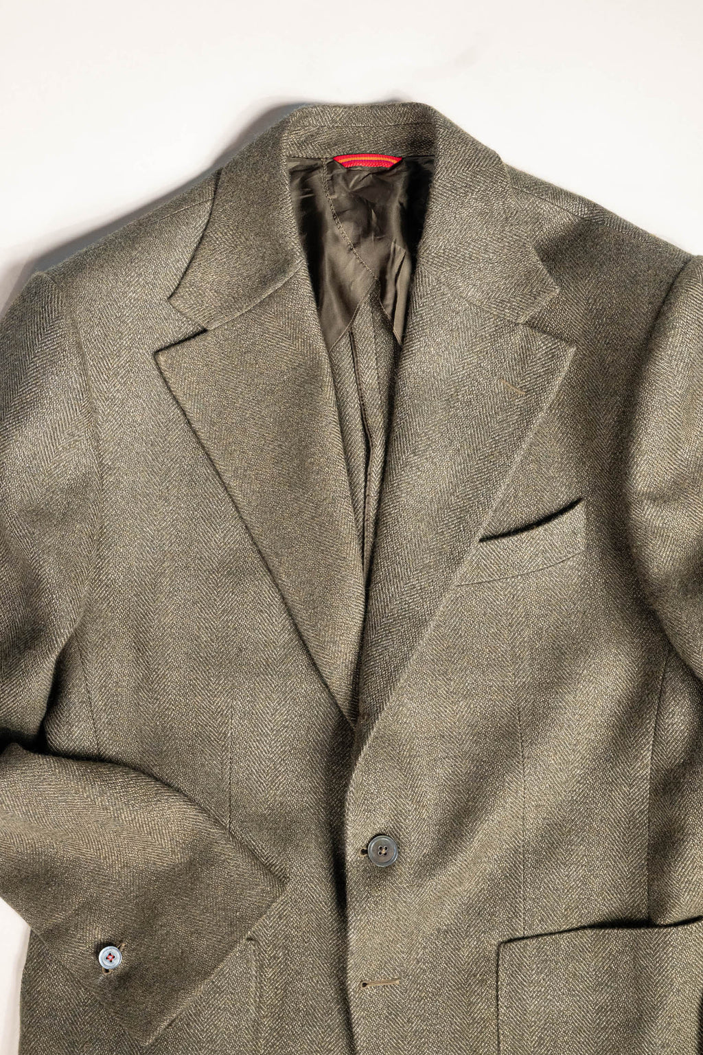 Refined menswear by Osman Abdul Razak olive herringbone jacket unpadded through the shoulder for ease
