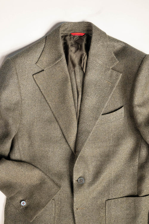 Refined menswear by Osman Abdul Razak olive herringbone jacket unpadded through the shoulder for ease