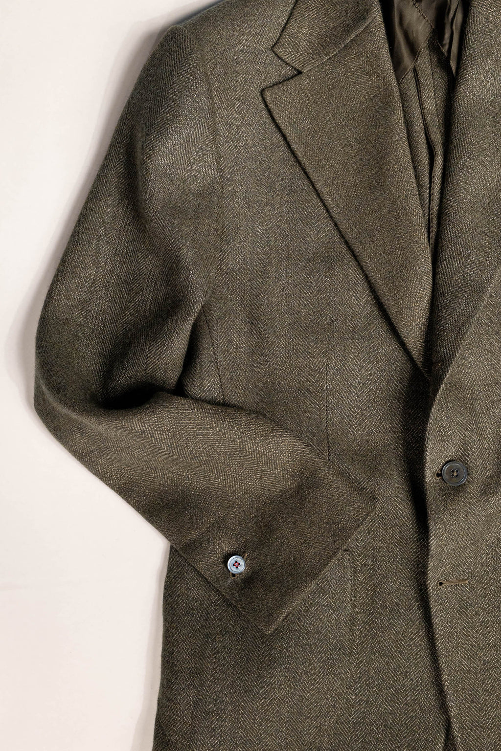Tailored menswear by Osman Abdul Razak olive herringbone jacket blending heritage with contemporary style