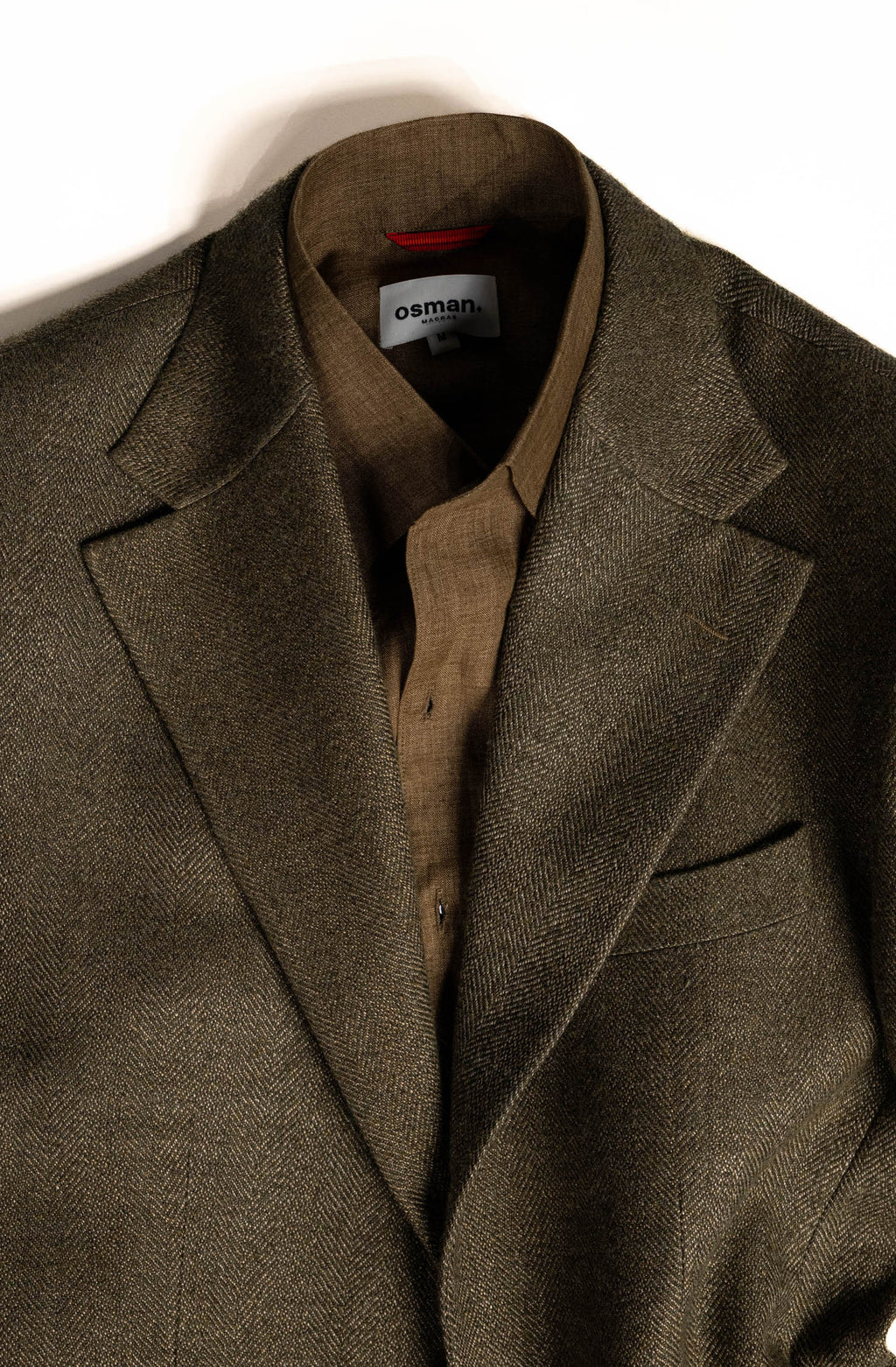 Elegant menswear by Osman Abdul Razak olive herringbone jacket designed as a modern tailoring staple