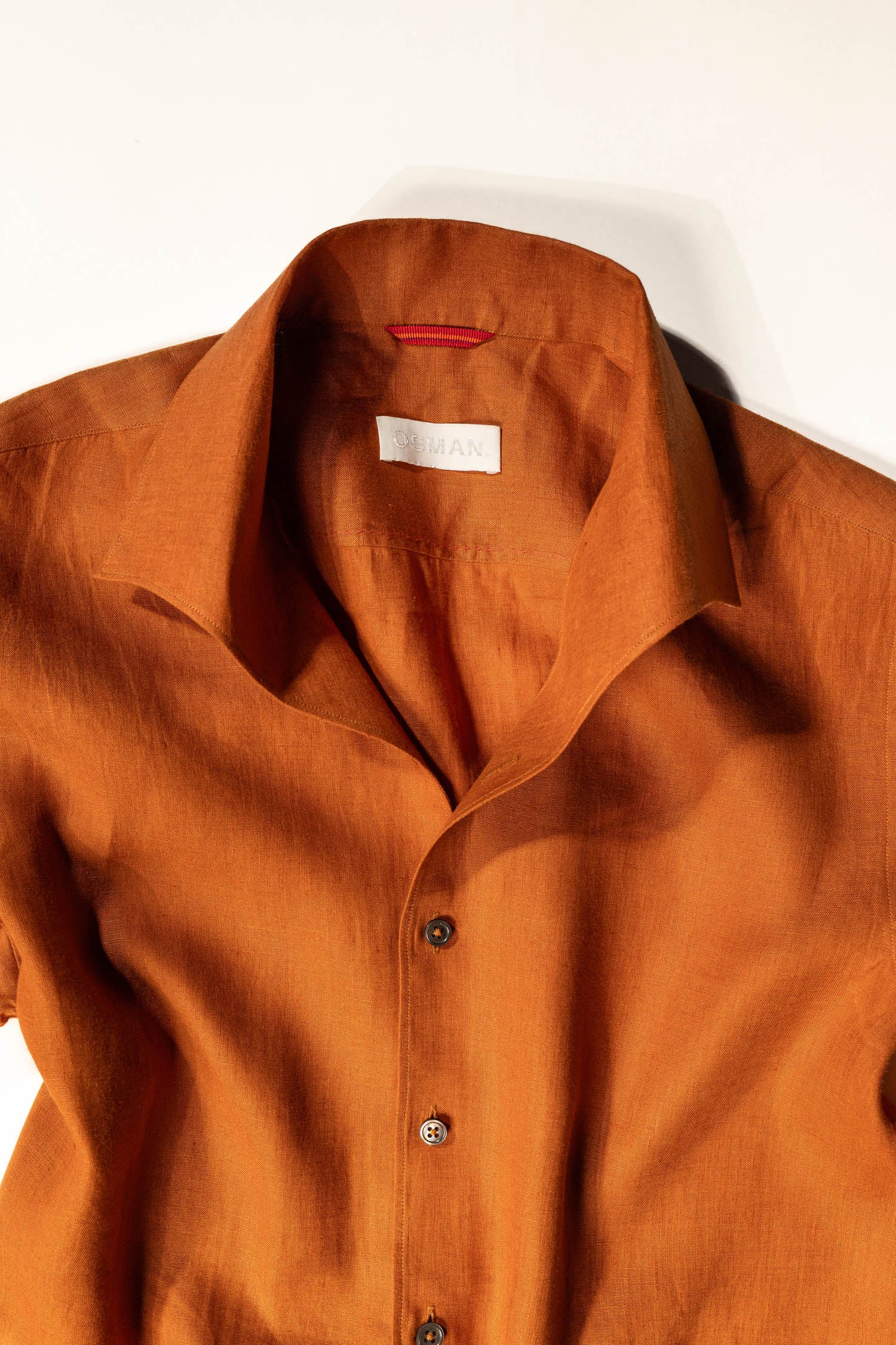 Refined menswear by Osman Abdul Razak earthy rust linen shirt with pleats embroidery
