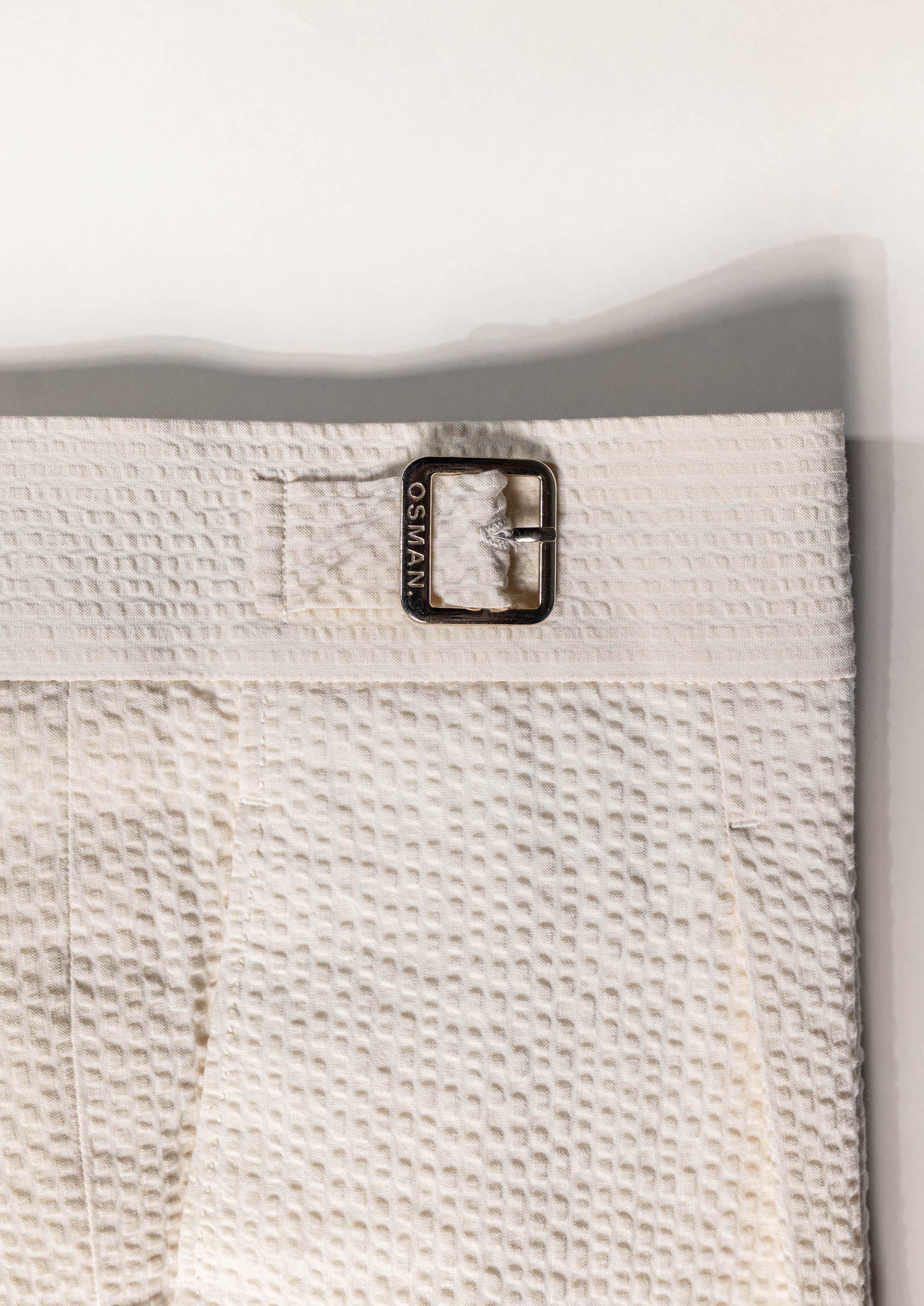 Refined summer menswear by Osman Abdul Razak – breathable eggshell trouser with subtle texture and light tone