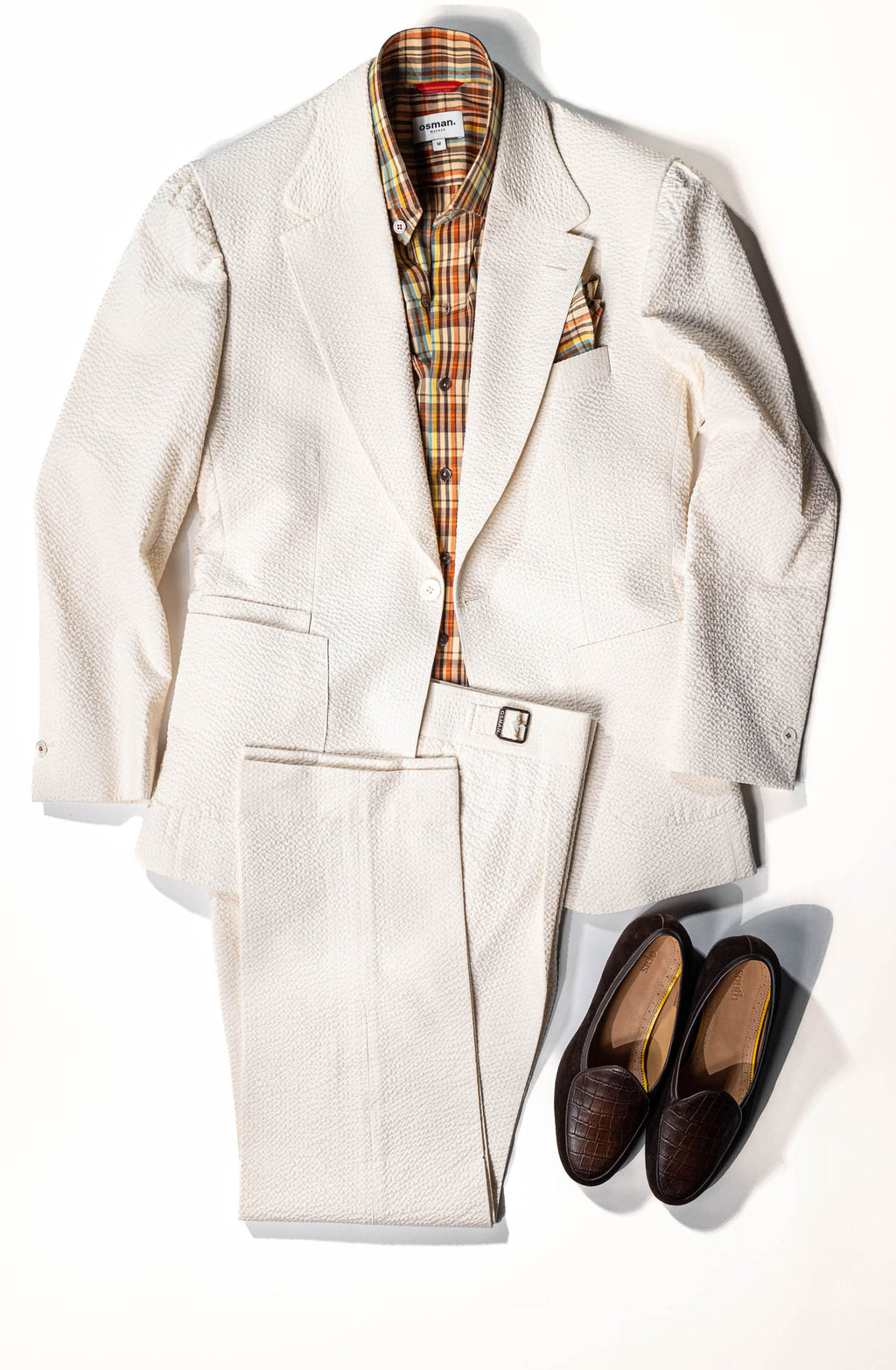 White suit jacket and pants with plaid shirt and shoes on a white background - osman-abdul-razak-menswear